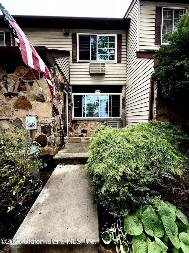 doorway to property with stone siding