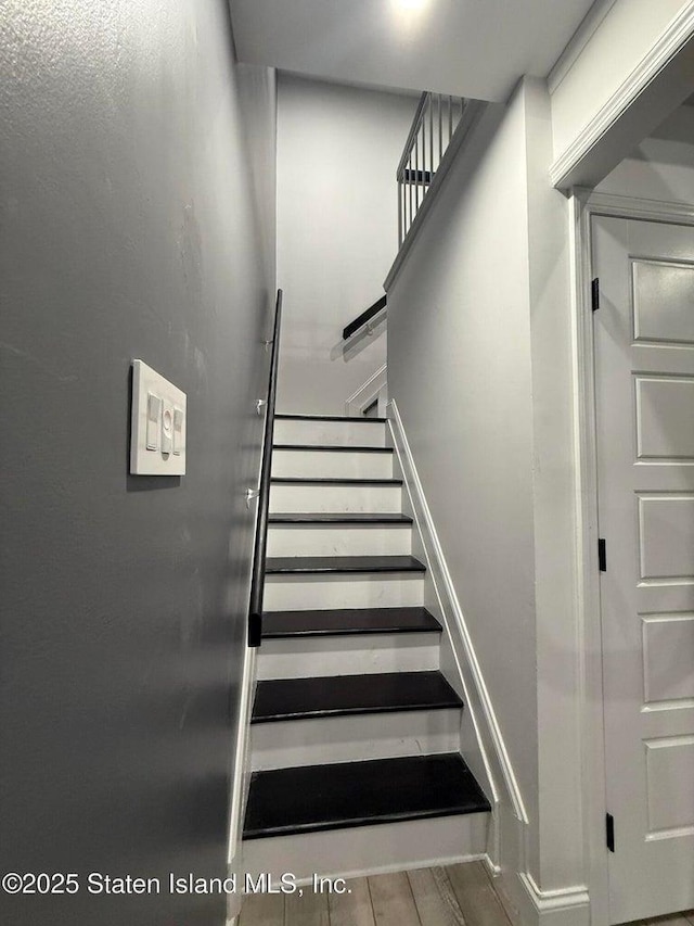 staircase featuring wood finished floors