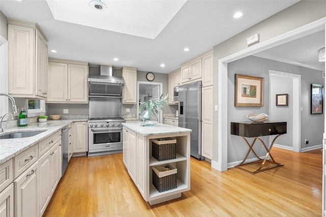 3 Briar Close Rd, Larchmont, NY 10538 - kitchen with high quality appliances, wall chimney exhaust hood, a sink, light wood-style flooring, and light stone countertops