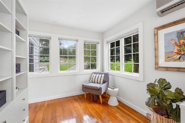 3 Briar Close Rd, Larchmont, NY 10538 - living area with an AC wall unit, baseboards, and light wood finished floors