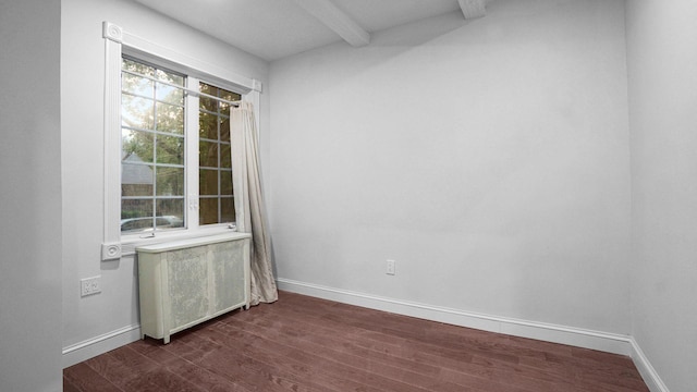 455 E 40th St, Brooklyn, NY 11203 - spare room with beamed ceiling, dark wood-type flooring, baseboards, and radiator heating unit