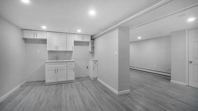 455 E 40th St, Brooklyn, NY 11203 - kitchen featuring baseboard heating, a sink, white cabinetry, recessed lighting, and baseboards