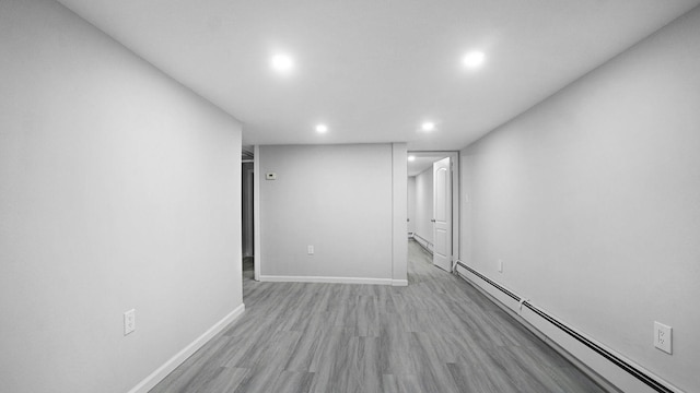 455 E 40th St, Brooklyn, NY 11203 - below grade area featuring a baseboard heating unit, recessed lighting, light wood finished floors, and baseboards