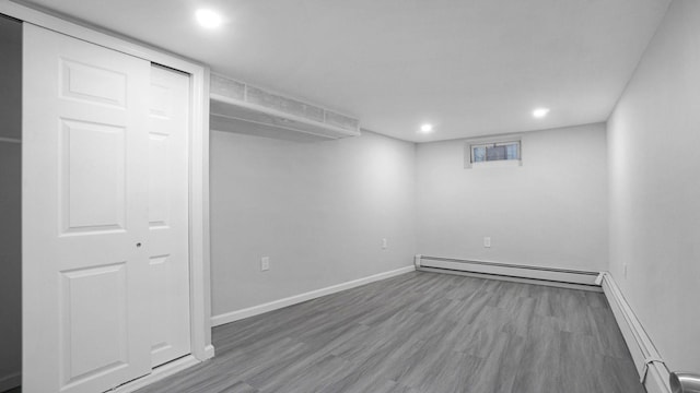 455 E 40th St, Brooklyn, NY 11203 - below grade area with baseboard heating, wood finished floors, recessed lighting, and baseboards