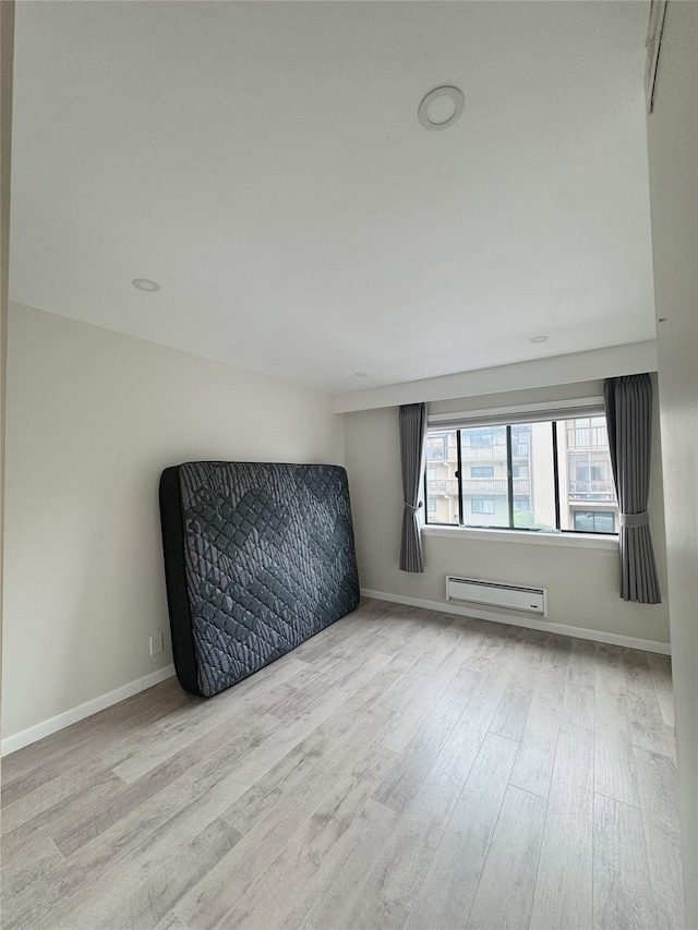 524 115th St Unit 524C, Flushing, NY 11356 - spare room featuring wood finished floors and baseboard heating