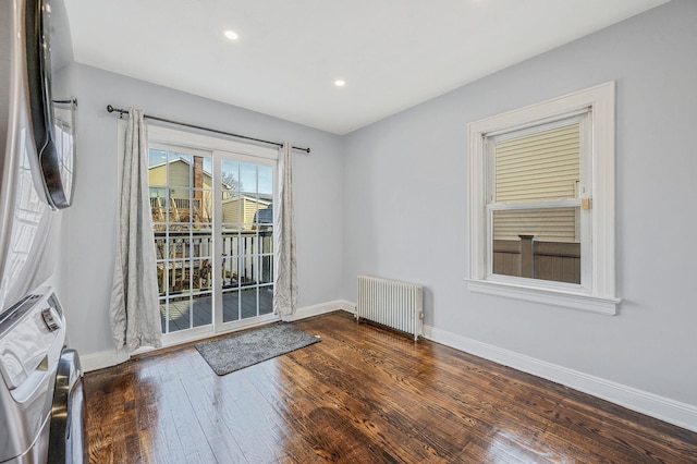 unfurnished room featuring radiator, wood-type flooring, baseboards, and recessed lighting