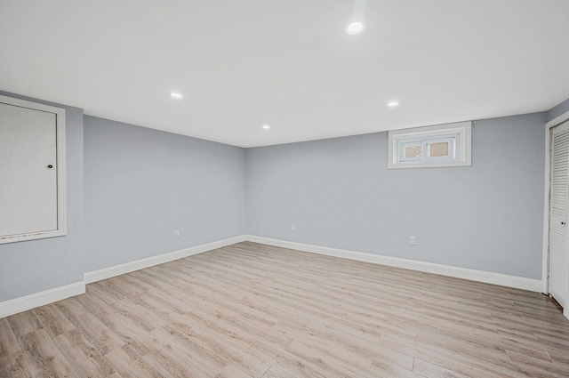 finished below grade area featuring wood finished floors, baseboards, and recessed lighting