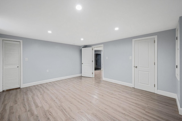 unfurnished living room with baseboards, light wood-style flooring, and recessed lighting