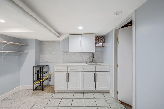 kitchen with a sink, open shelves, light countertops, light tile patterned flooring, and recessed lighting