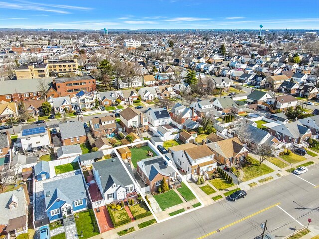 aerial view of property and surrounding area featuring nearby suburban area