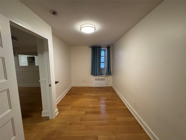 142-20 Franklin Ave Unit 2V, Flushing, NY 11355 - hallway featuring radiator, light wood finished floors, and baseboards