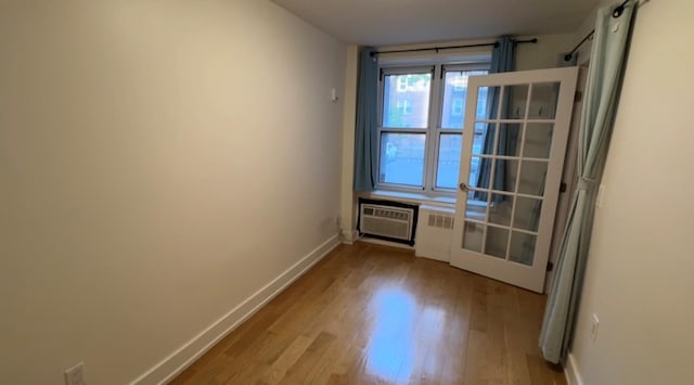 142-20 Franklin Ave Unit 2V, Flushing, NY 11355 - doorway to outside featuring wood finished floors, baseboards, and an AC wall unit