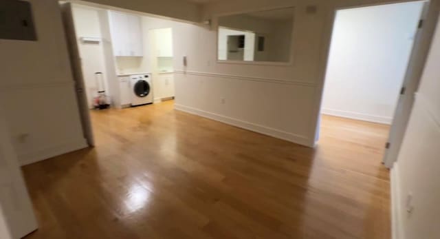 142-20 Franklin Ave Unit 2V, Flushing, NY 11355 - laundry area with washer / dryer, light wood-style floors, electric panel, cabinet space, and baseboards