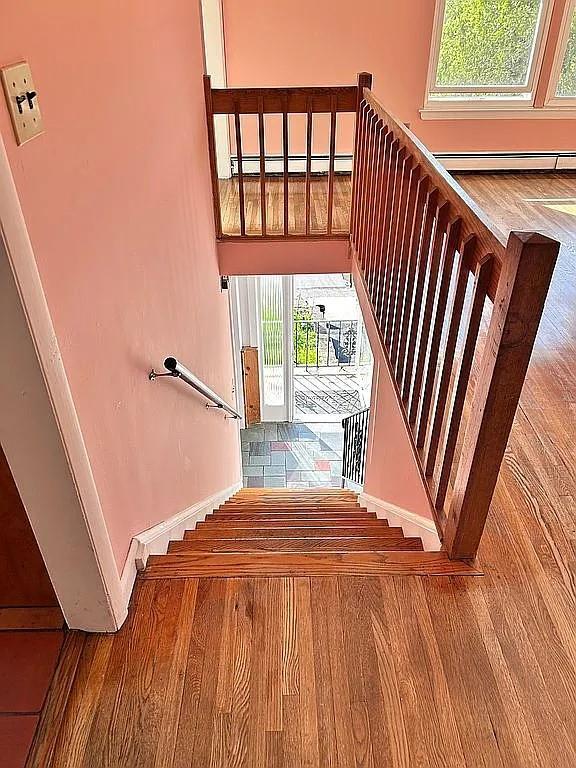102 Maple St, Croton-On-Hudson, NY 10520 - stairway featuring wood finished floors, baseboards, and a baseboard radiator