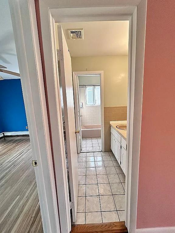 102 Maple St, Croton-On-Hudson, NY 10520 - bathroom with tile patterned floors, tile walls, and vanity