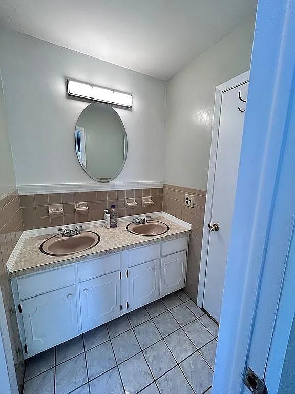 102 Maple St, Croton-On-Hudson, NY 10520 - bathroom with tile patterned floors, double vanity, and tile walls