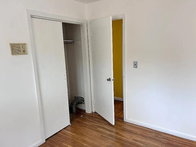 102 Maple St, Croton-On-Hudson, NY 10520 - unfurnished bedroom featuring wood finished floors, a closet, and baseboards