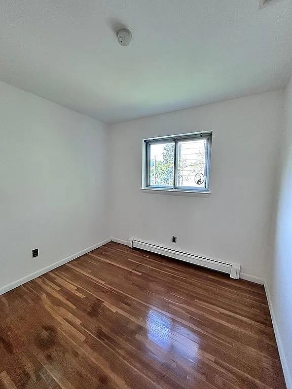 102 Maple St, Croton-On-Hudson, NY 10520 - unfurnished room with baseboard heating, wood finished floors, baseboards, and a smoke detector