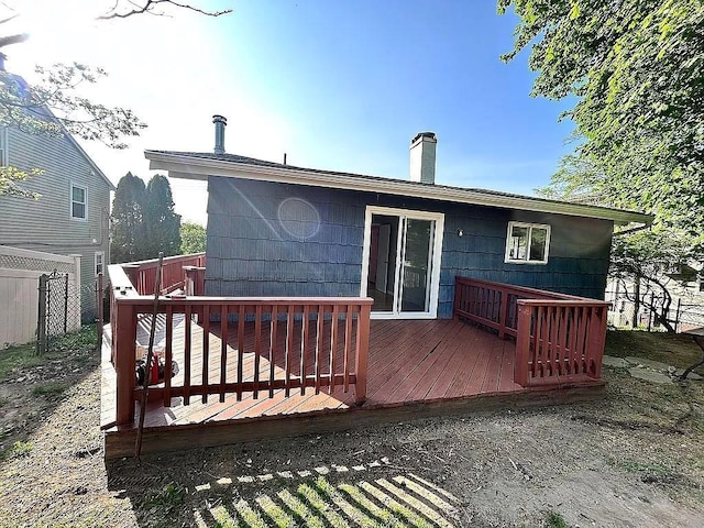 102 Maple St, Croton-On-Hudson, NY 10520 - rear view of property featuring a chimney, a deck, and fence