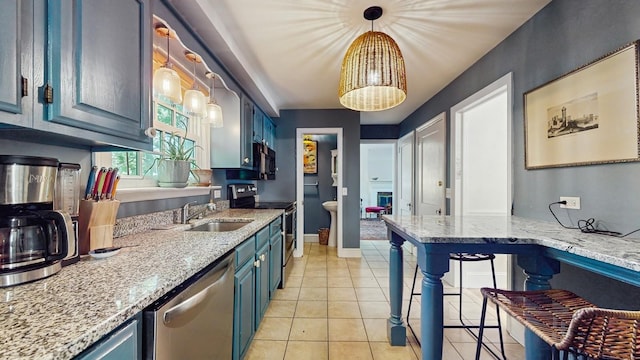 98 Jackson St, Fishkill, NY 12524 - kitchen featuring stainless steel appliances, blue cabinets, decorative light fixtures, light stone countertops, and light tile patterned floors