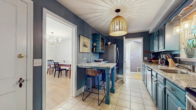 98 Jackson St, Fishkill, NY 12524 - kitchen featuring a chandelier, blue cabinetry, light tile patterned floors, and appliances with stainless steel finishes