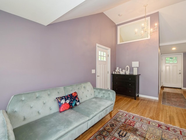 98 Jackson St, Fishkill, NY 12524 - living room featuring a chandelier, wood finished floors, and high vaulted ceiling