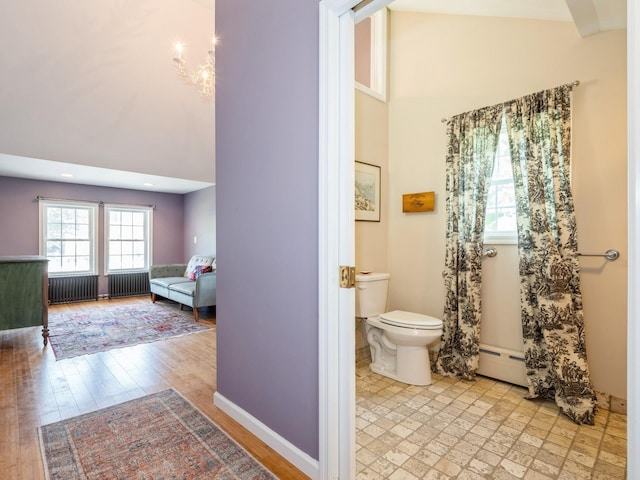 98 Jackson St, Fishkill, NY 12524 - bathroom featuring high vaulted ceiling, healthy amount of natural light, baseboard heating, radiator, and wood finished floors