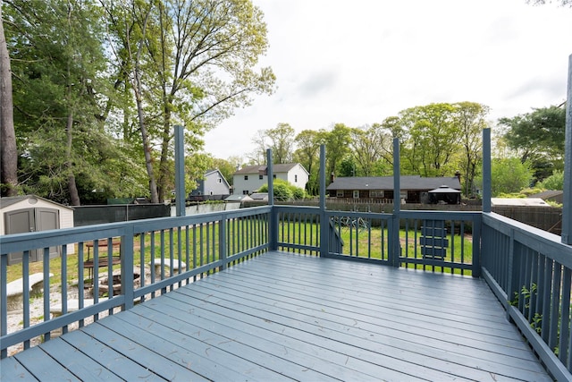 21 Pine Cone St, Middle Island, NY 11953 - wooden terrace with a shed, an outdoor structure, and a residential view