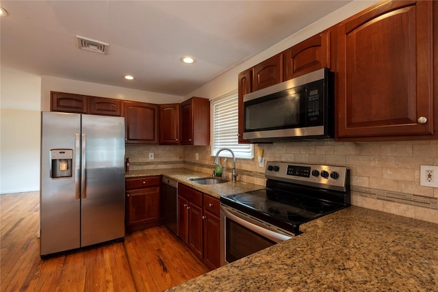 21 Pine Cone St, Middle Island, NY 11953 - kitchen featuring appliances with stainless steel finishes, a sink, wood finished floors, recessed lighting, and light stone counters