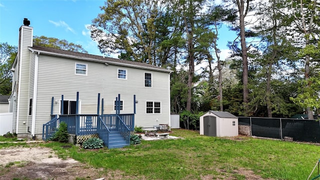 21 Pine Cone St, Middle Island, NY 11953 - back of property featuring a shed, a wooden deck, a chimney, and an outdoor structure