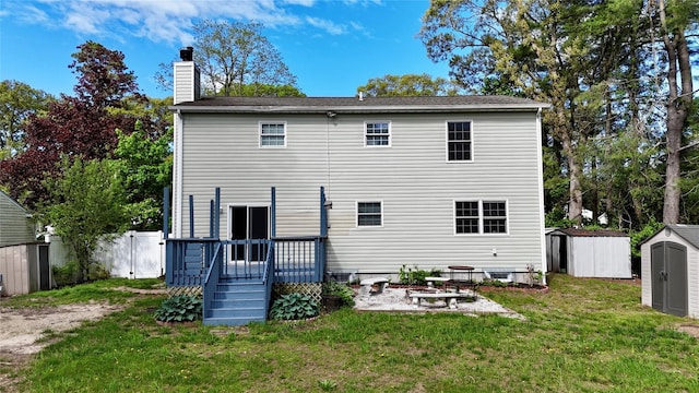 21 Pine Cone St, Middle Island, NY 11953 - back of property featuring a storage shed, a deck, a patio, an outdoor structure, and a chimney