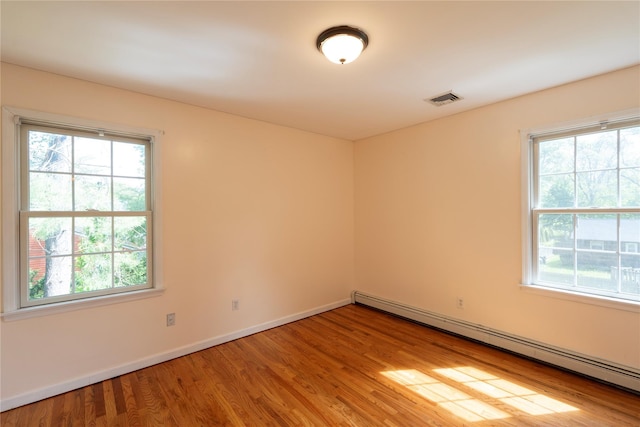 21 Pine Cone St, Middle Island, NY 11953 - spare room with a baseboard radiator, healthy amount of natural light, and light wood-type flooring