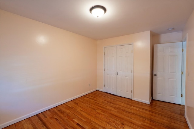 21 Pine Cone St, Middle Island, NY 11953 - unfurnished bedroom with baseboards, light wood-style flooring, and a closet