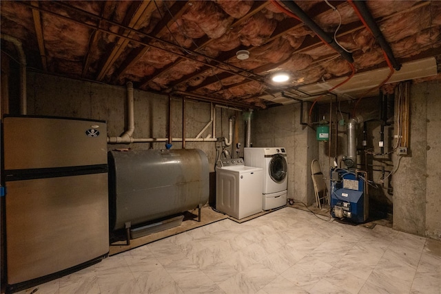21 Pine Cone St, Middle Island, NY 11953 - unfinished basement with freestanding refrigerator, oil tank, washing machine and clothes dryer, a heating unit, and light floors