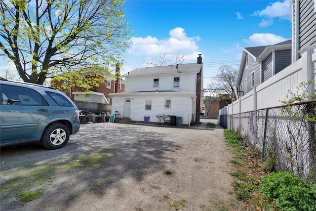 101 Baldwin Rd, Hempstead, NY 11550 - back of house featuring fence and a chimney