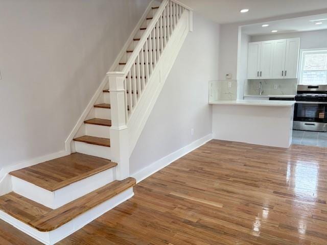 187-02 Foch Blvd, Saint Albans, NY 11412 - stairs featuring wood finished floors, recessed lighting, and baseboards