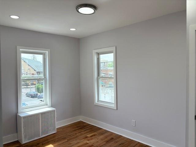187-02 Foch Blvd, Saint Albans, NY 11412 - empty room with plenty of natural light, baseboards, dark wood-style floors, and recessed lighting
