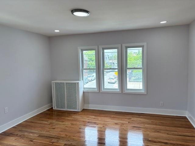 187-02 Foch Blvd, Saint Albans, NY 11412 - unfurnished room with healthy amount of natural light, wood finished floors, baseboards, and recessed lighting