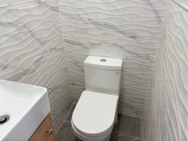 187-02 Foch Blvd, Saint Albans, NY 11412 - half bathroom with toilet, vanity, and tile walls