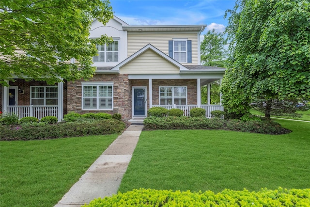 27 Lager Ln, Patchogue, NY 11772 - view of front of home with a porch, stone siding, and a front yard