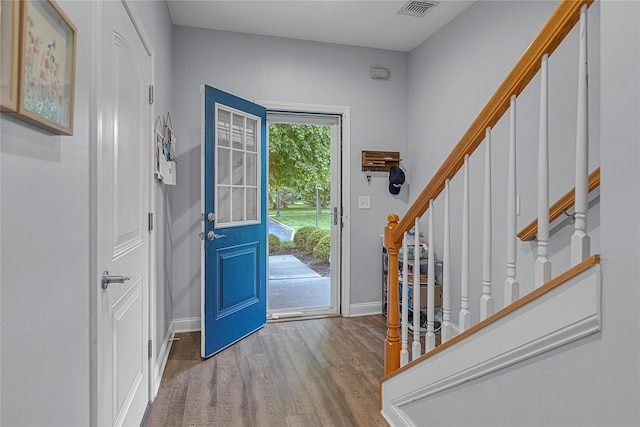 27 Lager Ln, Patchogue, NY 11772 - foyer with wood finished floors, baseboards, and stairs