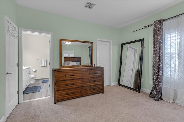 27 Lager Ln, Patchogue, NY 11772 - bedroom featuring light colored carpet, connected bathroom, and baseboards