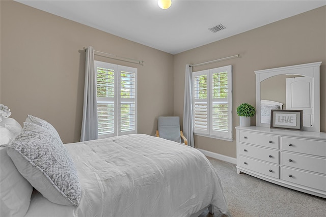 27 Lager Ln, Patchogue, NY 11772 - bedroom featuring light carpet, multiple windows, and baseboards