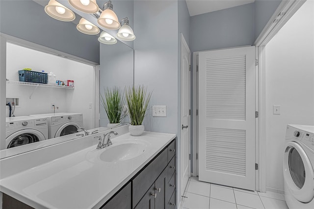 27 Lager Ln, Patchogue, NY 11772 - bathroom featuring washing machine and dryer, tile patterned flooring, and vanity