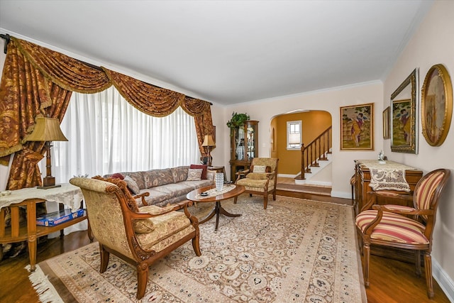 182-04 80th Dr, Jamaica Estates, NY 11432 - living room with arched walkways, wood finished floors, baseboards, ornamental molding, and stairs
