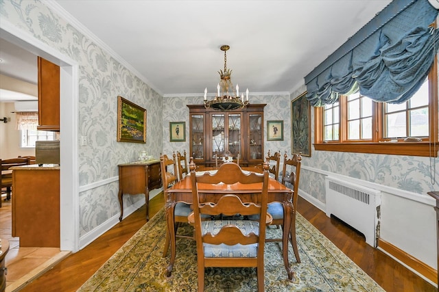 182-04 80th Dr, Jamaica Estates, NY 11432 - dining space with radiator heating unit, wallpapered walls, a chandelier, wood finished floors, and baseboards