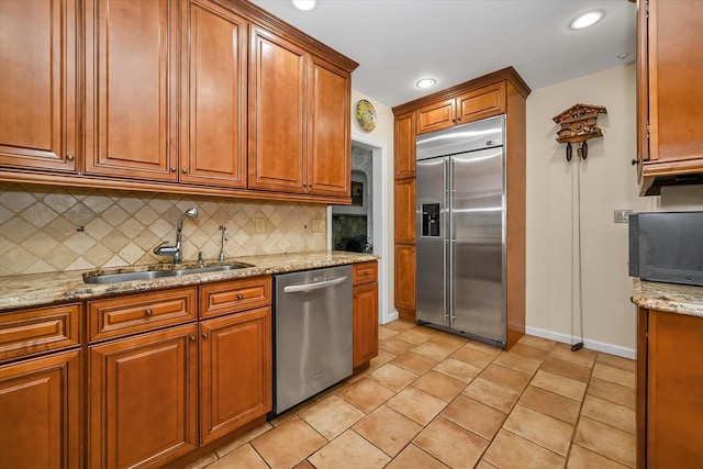 182-04 80th Dr, Jamaica Estates, NY 11432 - kitchen featuring appliances with stainless steel finishes, a sink, backsplash, baseboards, and brown cabinets