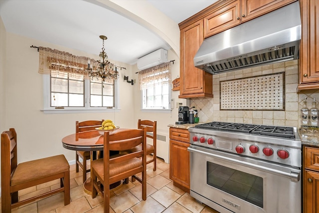 182-04 80th Dr, Jamaica Estates, NY 11432 - kitchen featuring luxury range, under cabinet range hood, brown cabinets, a wall mounted AC, and a chandelier