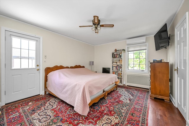 182-04 80th Dr, Jamaica Estates, NY 11432 - bedroom with radiator heating unit, a wall unit AC, wood finished floors, ceiling fan, and baseboards