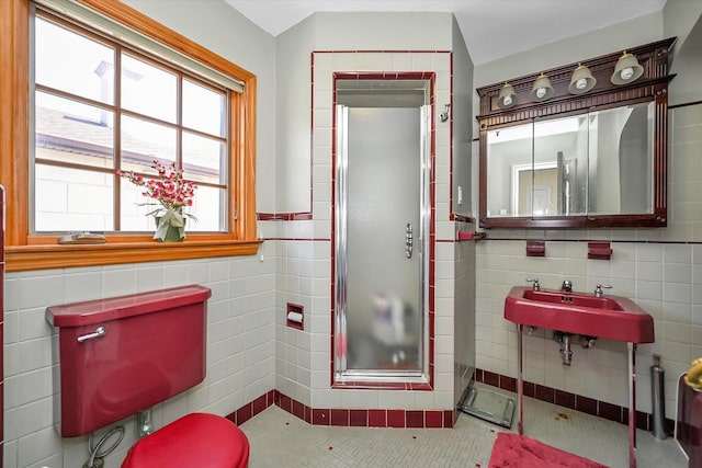 182-04 80th Dr, Jamaica Estates, NY 11432 - bathroom with tile walls, a shower stall, a sink, wainscoting, and tile patterned floors
